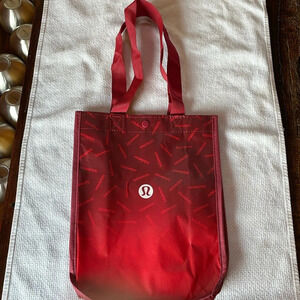 LULULEMON RED REUSABLE SMALL TOTE. Ombré w/ lululemon hits scattered all over